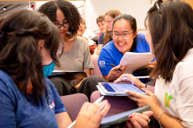 Victoria Zambrano ’27 (clockwise from bottom left), JaKayla C. Harris ’27, Ida Chen ’27, and Kodi Kim ’27 working together during “Introductory Electromagnetism Physics.”  Niles Singer/Harvard Staff Photographer