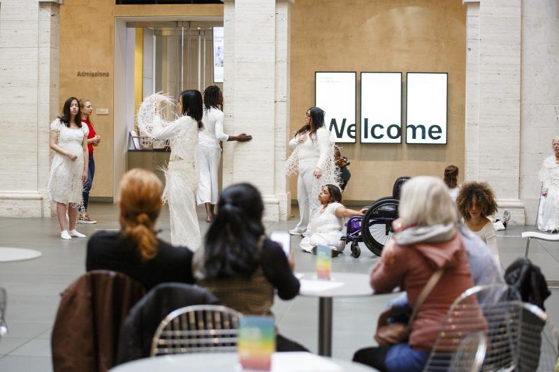 Audience members watch performance inside Harvard Art Museum 