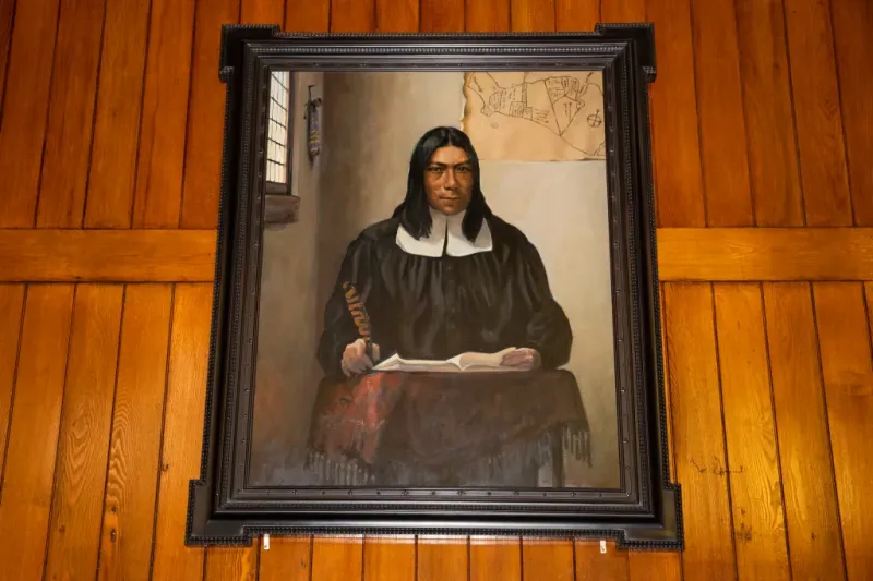 A portrait of Caleb Cheeshahteaumuck, the first Native American to graduate from Harvard College, hangs in Annenberg Hall.