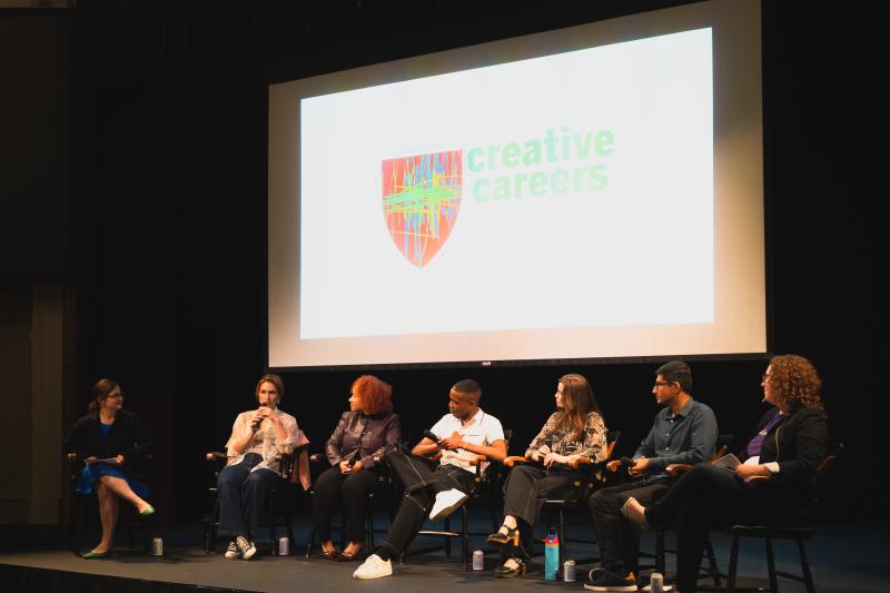 Panelists sit on stage under a screen displaying "creative careers."