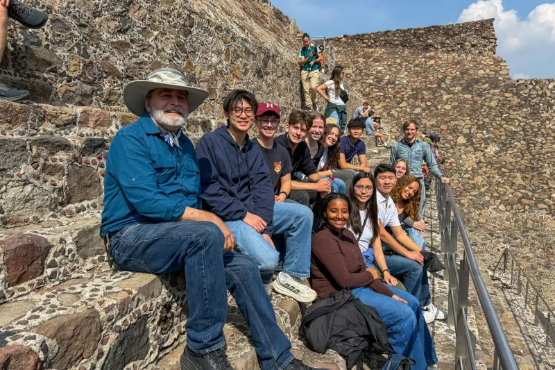 Professors and students sitting at the Pyramid at the Sun in Mexico.