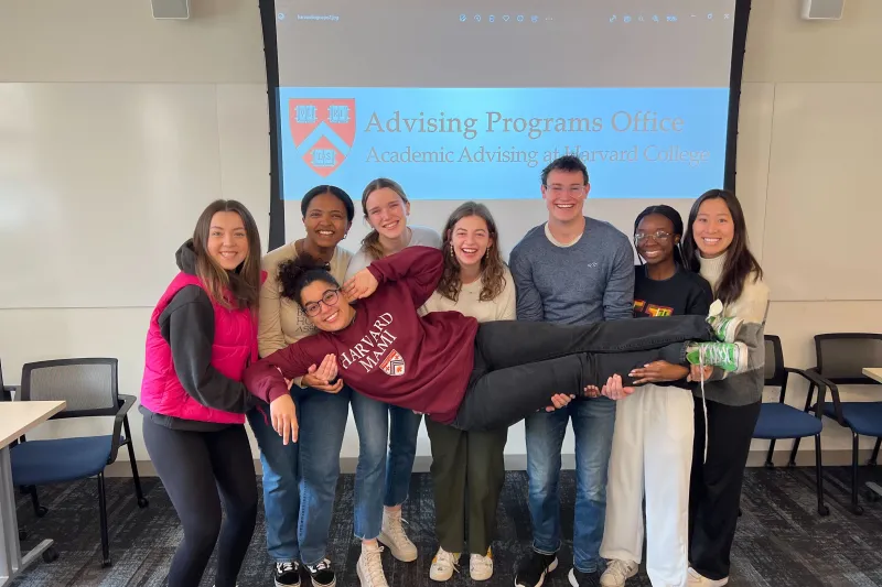 A group of PAF students holding up a female student.