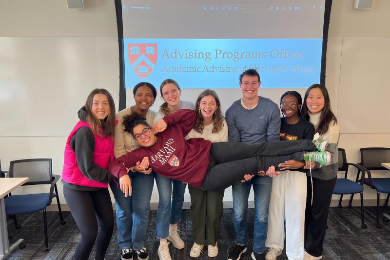 A group of PAF students holding up a female student.