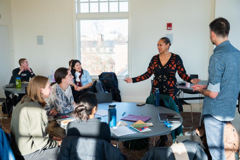 Reverand Mariama standing in the front of the room speaking to the students.