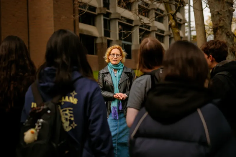Joyce Chaplin, James Duncan Phillips Professor of Early American History, speaking with students outside the Center for Astrophysics.