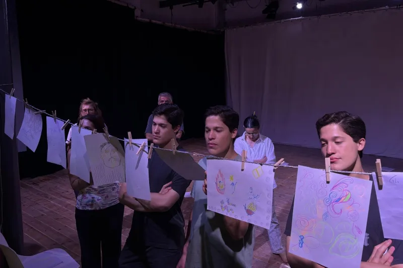 Identical triplets Carlos, Federico, and Francisco Valldejuly ʼ29 studying artwork together during their internship.