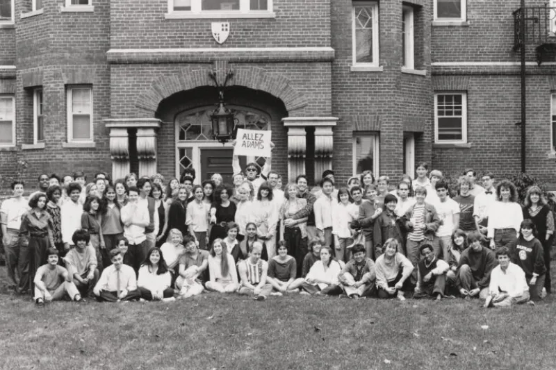 A group of students posing for a picture together outside of Adams House in 1987.