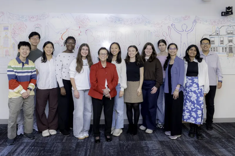 A group of peer tutor students smiling for a photo with donor Beverly J. Duran, center.
