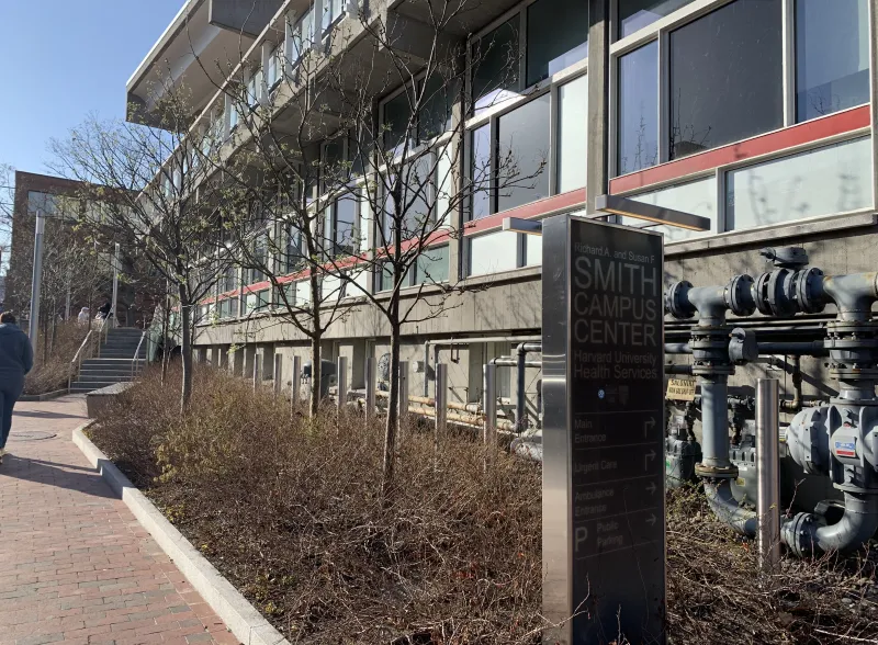 Mt. Auburn Street Side of Harvard University Health Services showing the sidewalk, building and the entrance sign