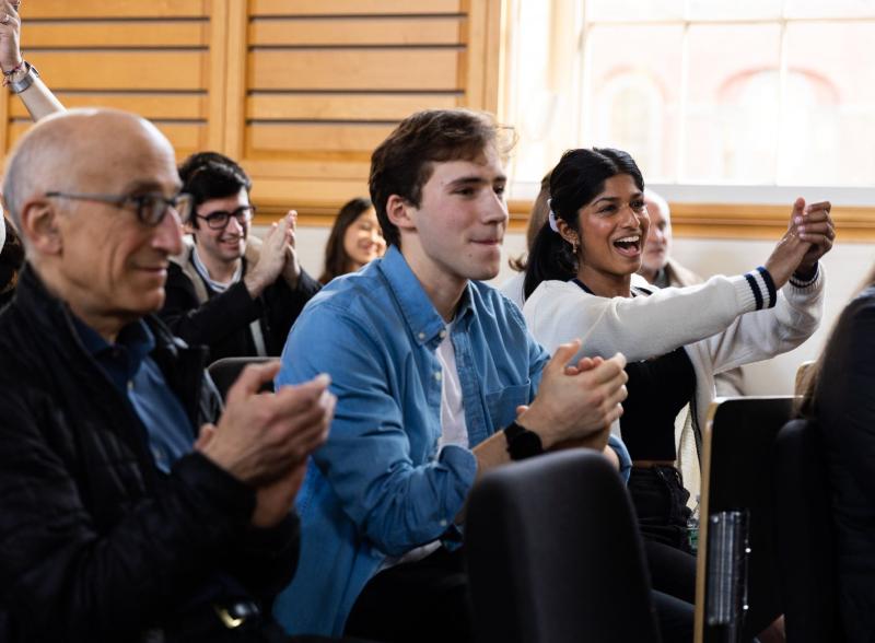 Audience members applaud at Arts First