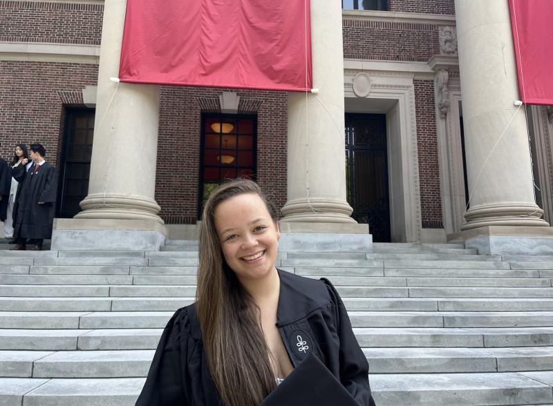 Harvard graduate Perrin Price standing on Widener Library steps.