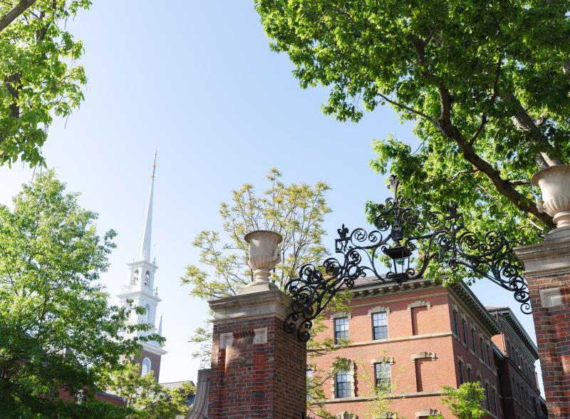 Gate and Memorial Church Spire in the background with green trees