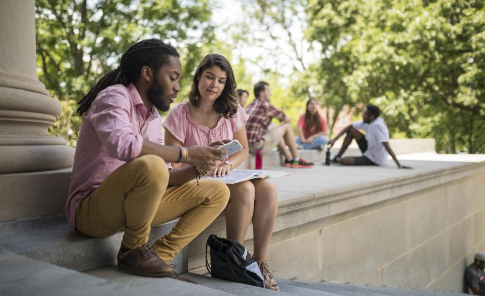 Two students looking at a cell phone