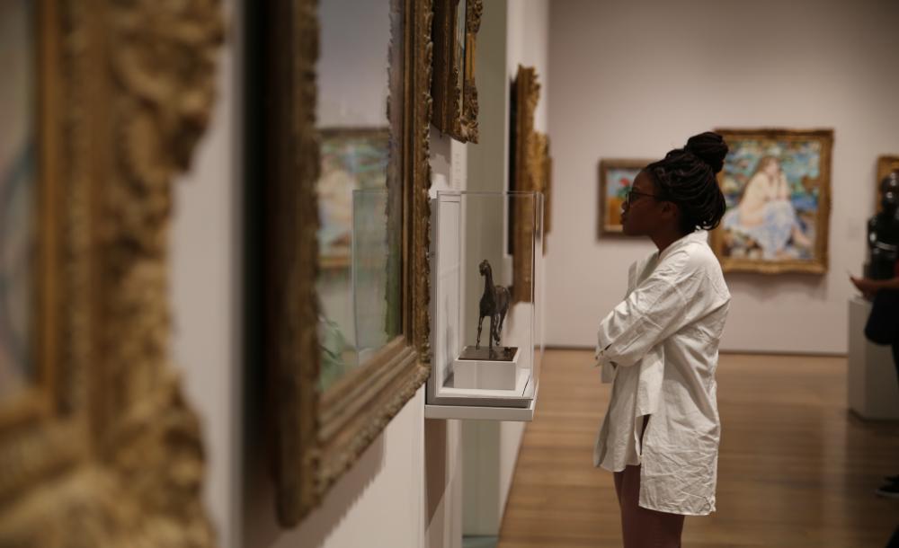 student looking at Art in the art museum