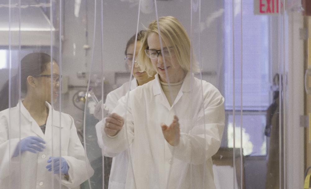 Professor in a science lab with students