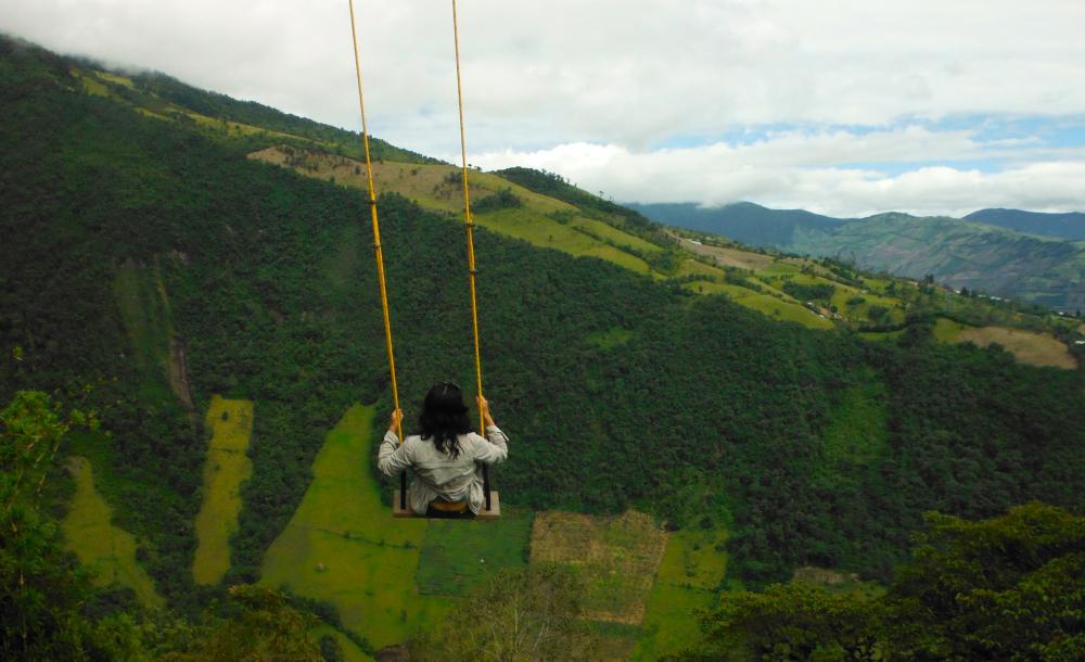 A girl sits on a swing in Ecuador