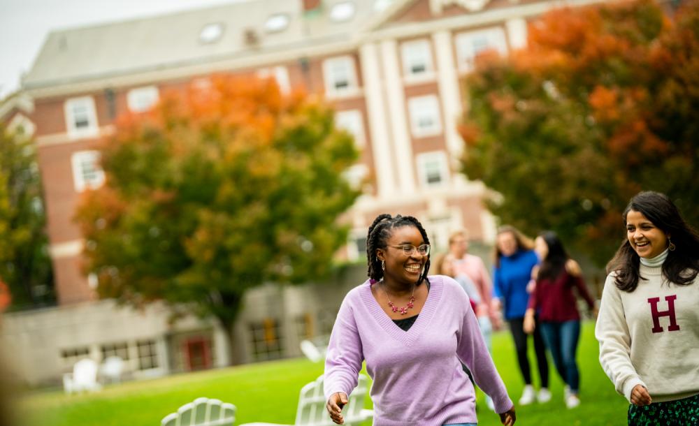 Two female students walking through the Radcliffe Quad