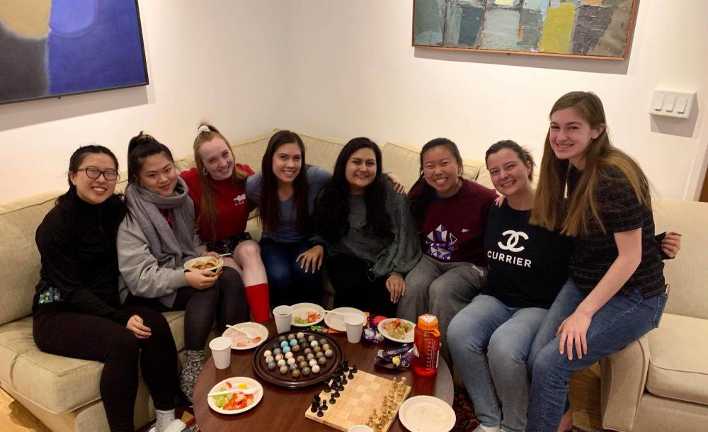 Maria posing with her friend group in Currier House, one of the upperclassmen dorms.