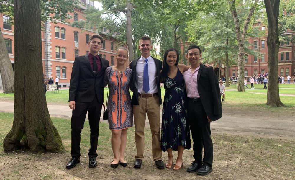 Five Harvard students posing in the Yard at Convocation