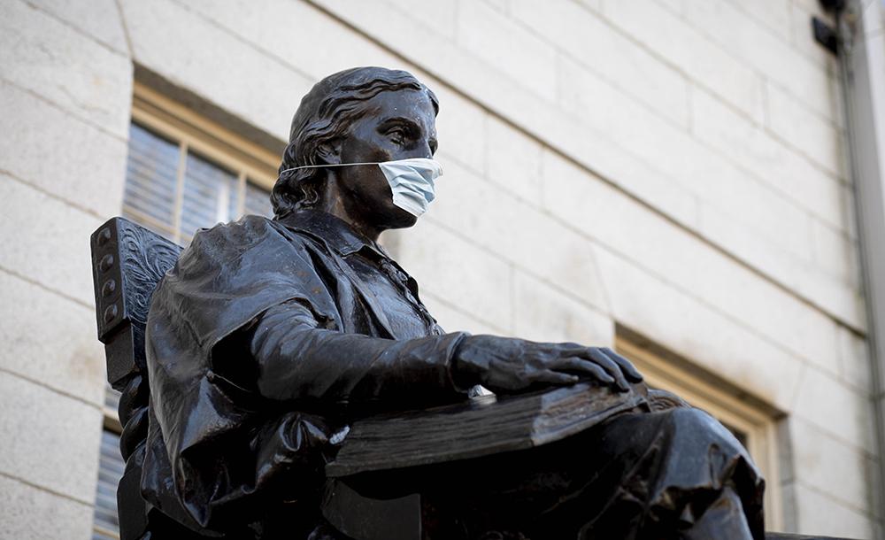 John Harvard Statue wearing a Mask
