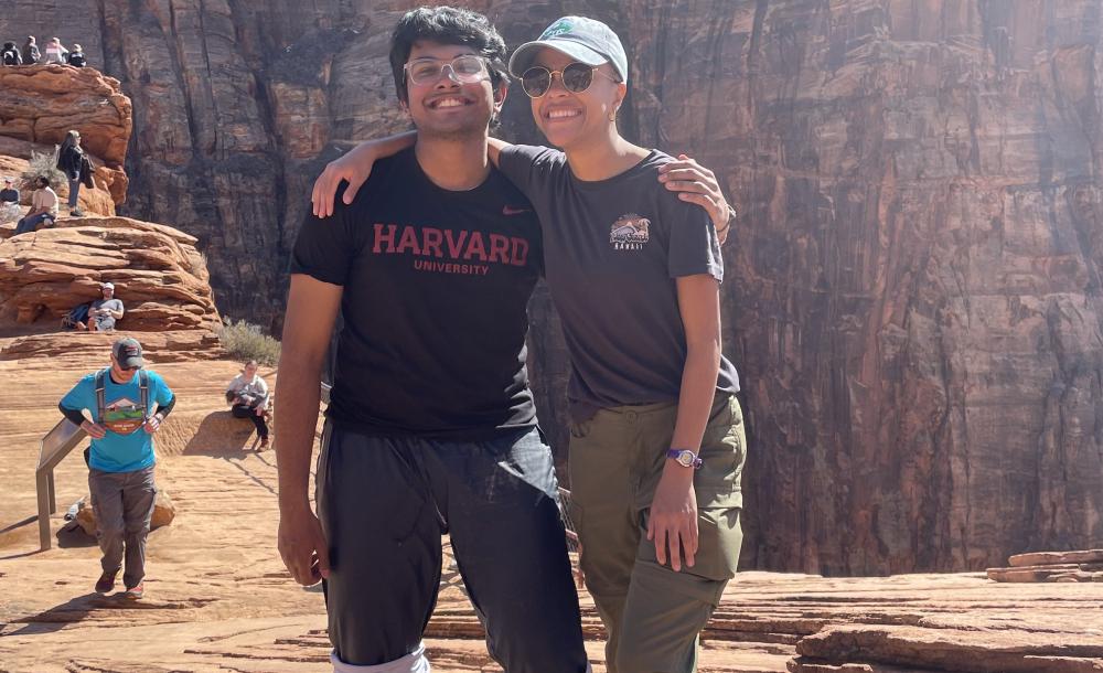 An image of Rafid standing next to FOP director Lesedi Graveline in front of the canyons of Zion National Park, both of them smiling
