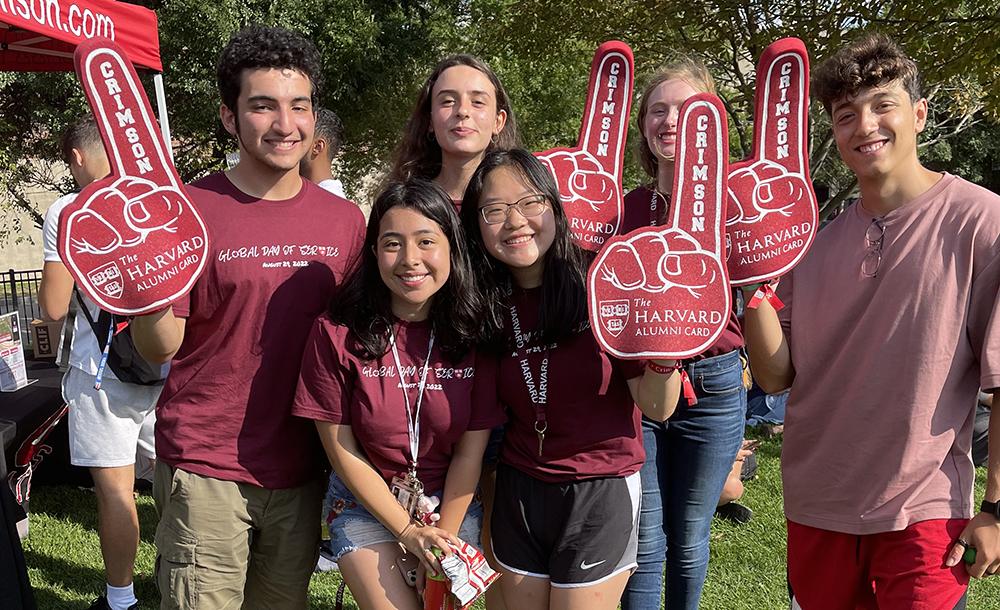 a group of students wearing crimson fan foam finger