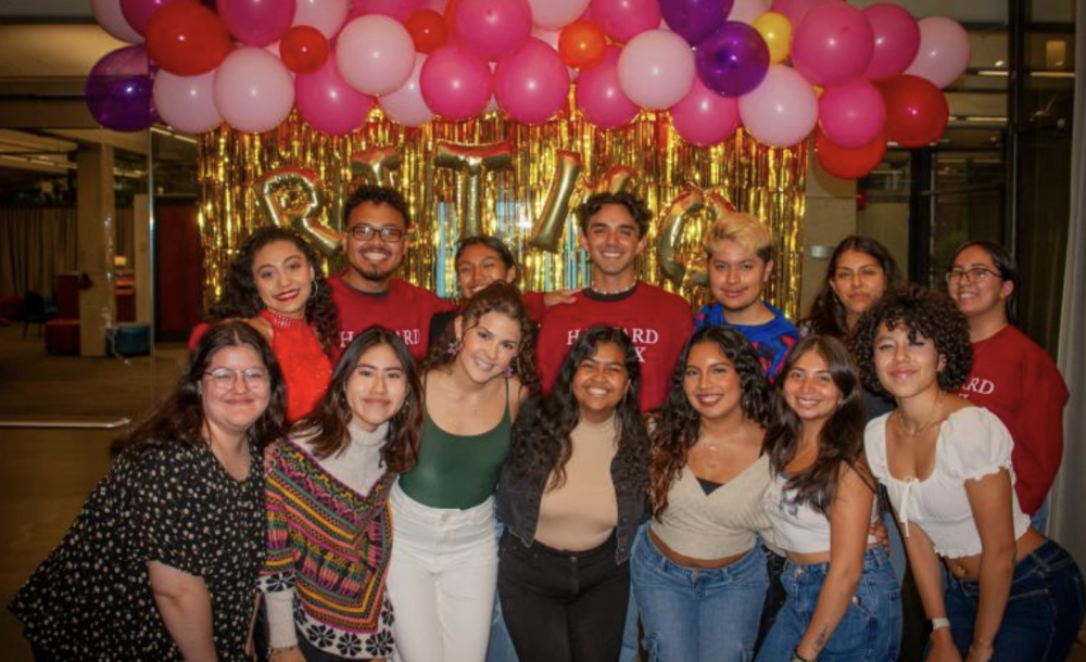 Fuerza Latina Board Posing In Front of a Ritmo Latino Sign