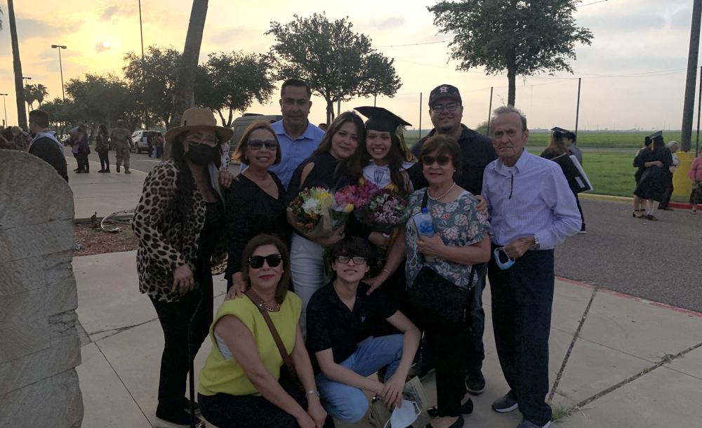 Ana with her family member at her high school graduation.