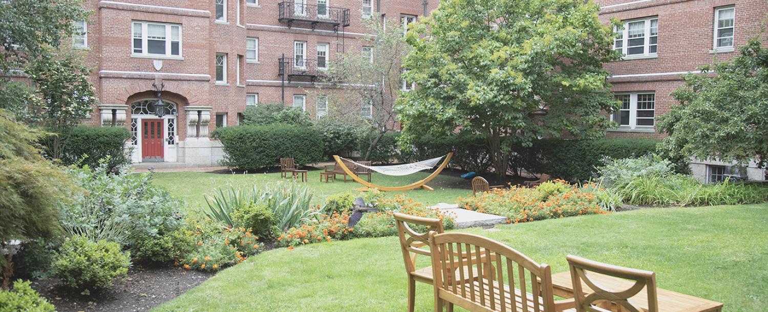 A small green area sits between a few buildings.