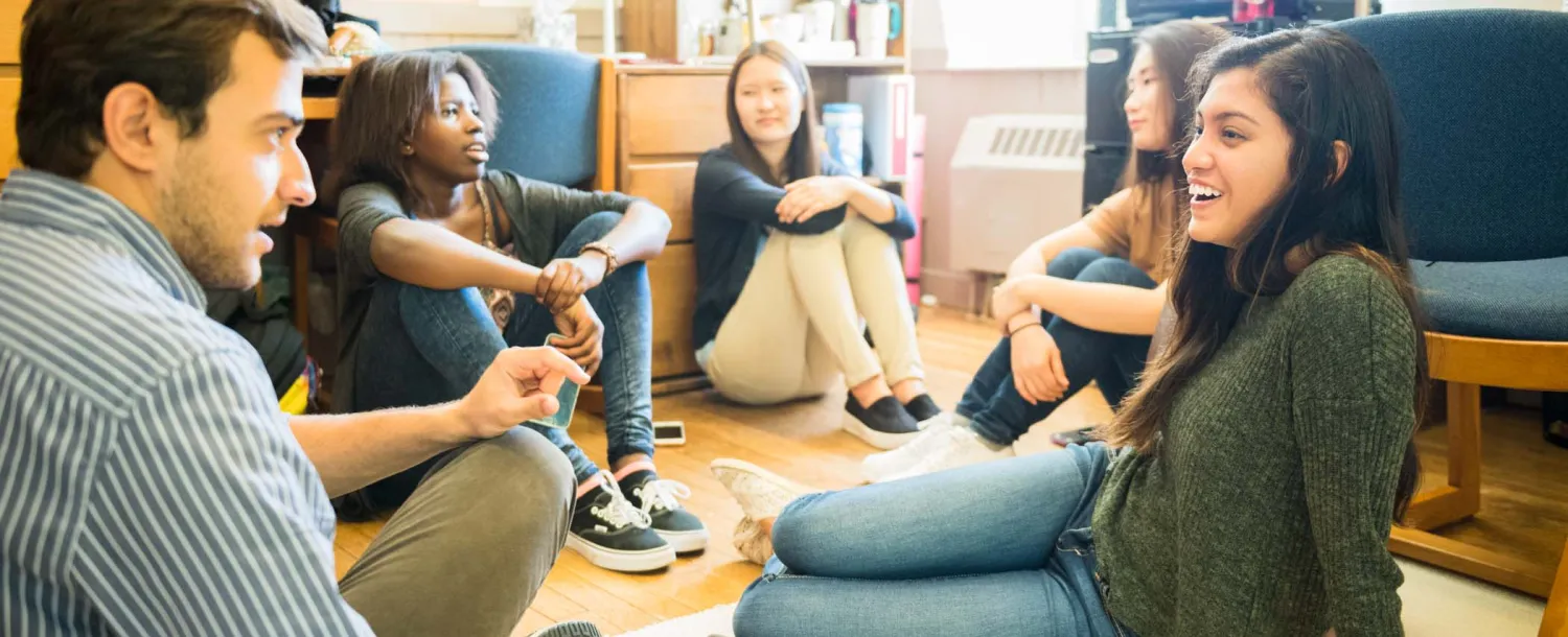 students in their dorm sitting around talking