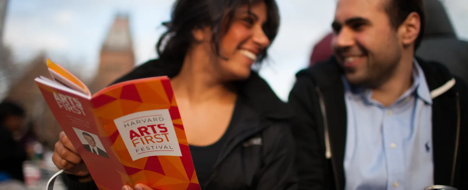Man and woman looking at ARTS FIRST program