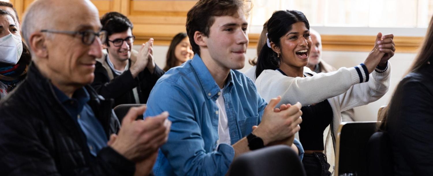 Audience members applaud at Arts First