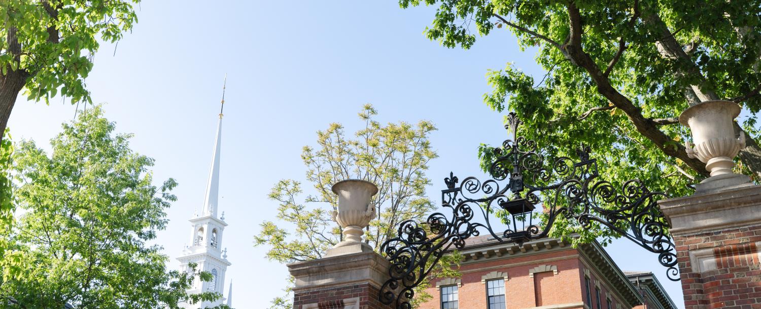 Gate and Memorial Church Spire in the background with green trees