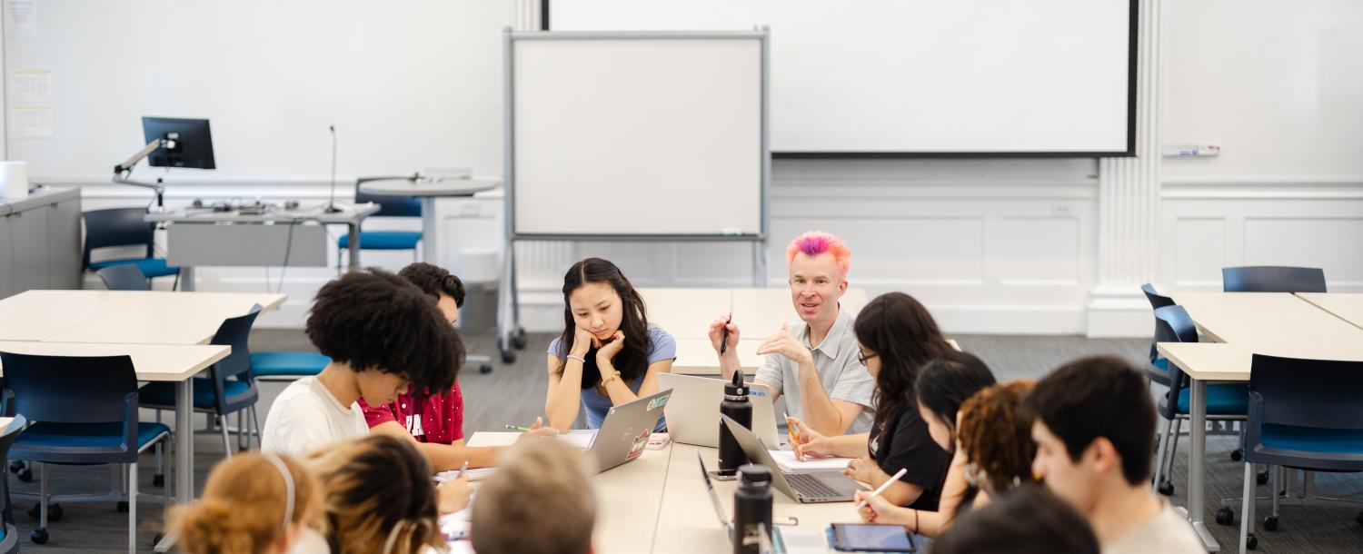 Students sit around a classroom with a professor