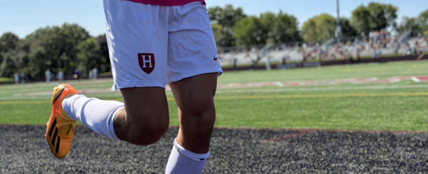 A soccer student running sideline drills to warm up during a game.