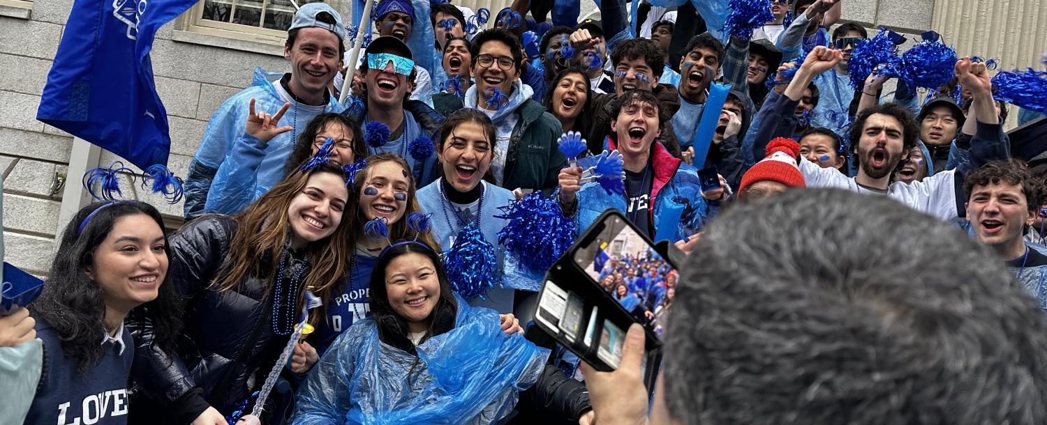 Dean Khurana takes a photo of Lowell House students on the steps of University Hall during Housing Day for his Instagram.