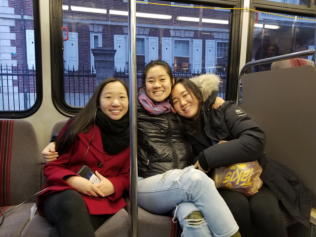 three students riding the subway