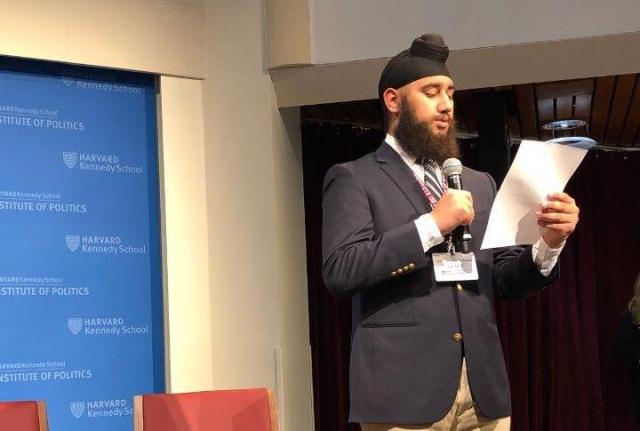 a student on stage at Harvard's JFK Jr. Forum