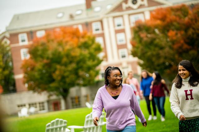 Two female students walking through the Radcliffe Quad