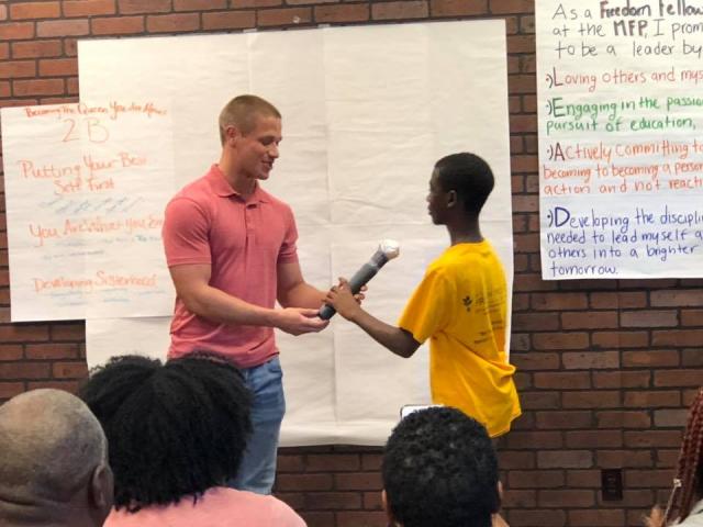 Two Students holding a microphone