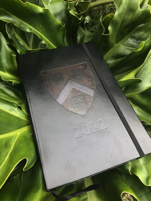 Black journal with Harvard logo and 2022 imprinted on the front
