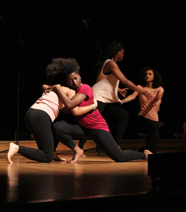 This image shows 4 dancers embracing each other at last year's Kuumba Winter Concert.