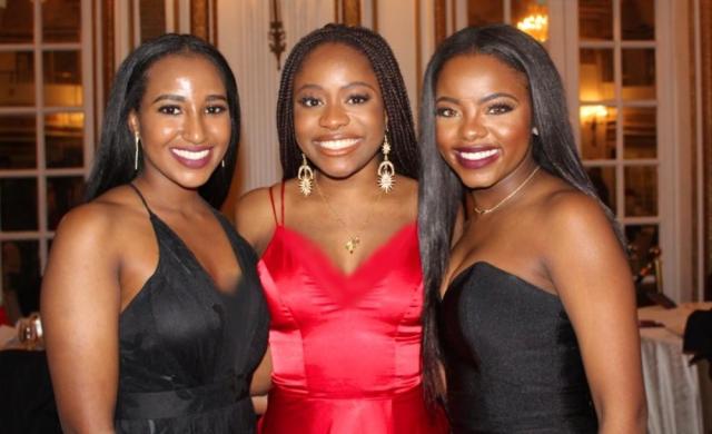 My two best friends and I, smiling, at a gala.