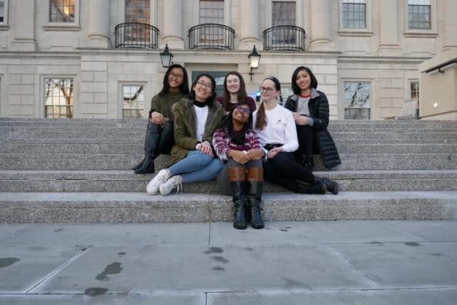 6 ladies sitting on the steps outside of Winthrop House