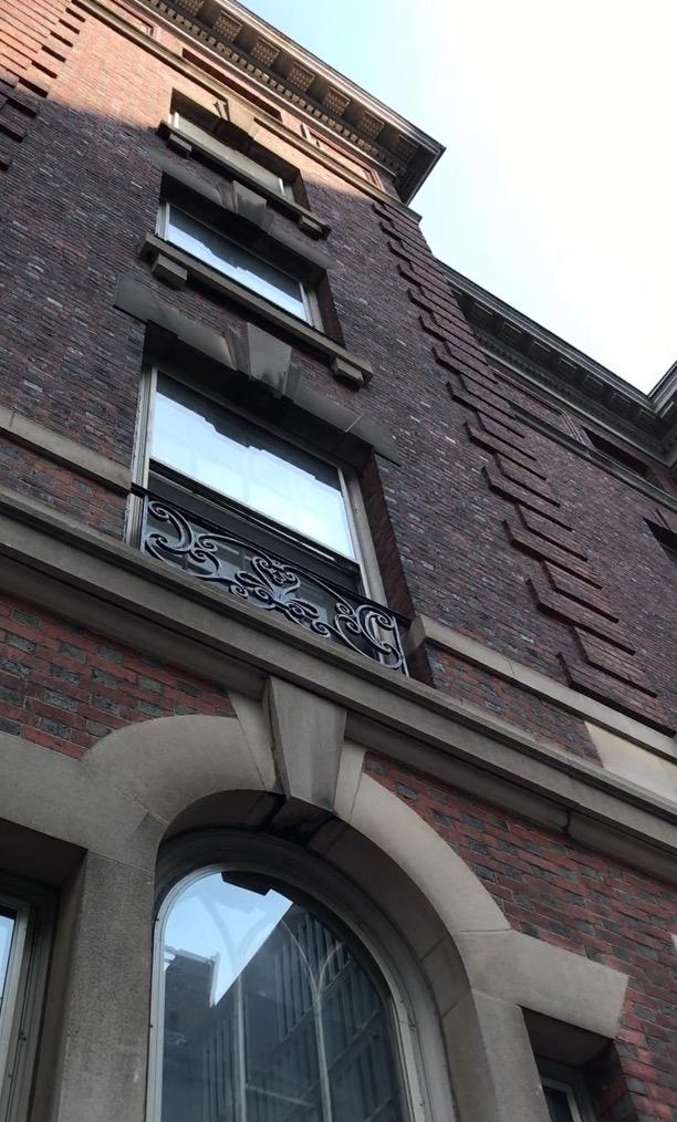 Photo of side of apartment style dorm building with shadows