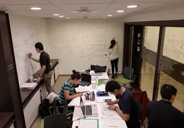 5 students studying in the basement of dorm.