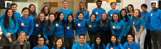 Group of smiling students in blue shirts