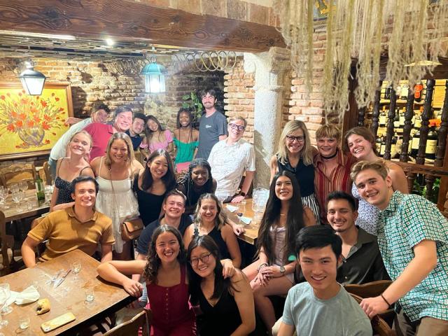 Group picture of students and professors at final dinner celebration 