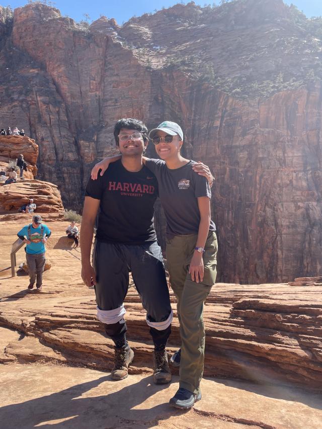 An image of Rafid standing next to FOP director Lesedi Graveline in front of the canyons of Zion National Park, both of them smiling