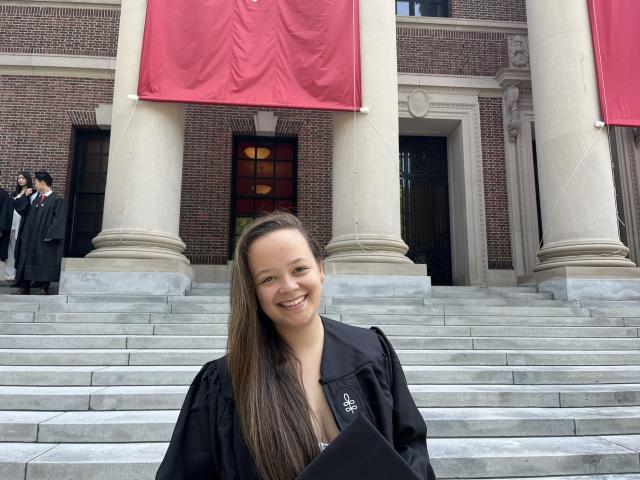 Harvard graduate Perrin Price standing on Widener Library steps.